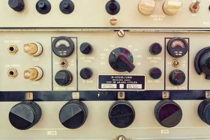 A bunch of knobs and switches on a wall